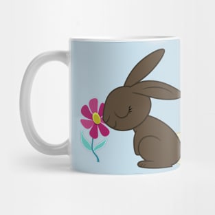 Bunny smelling a flower Mug